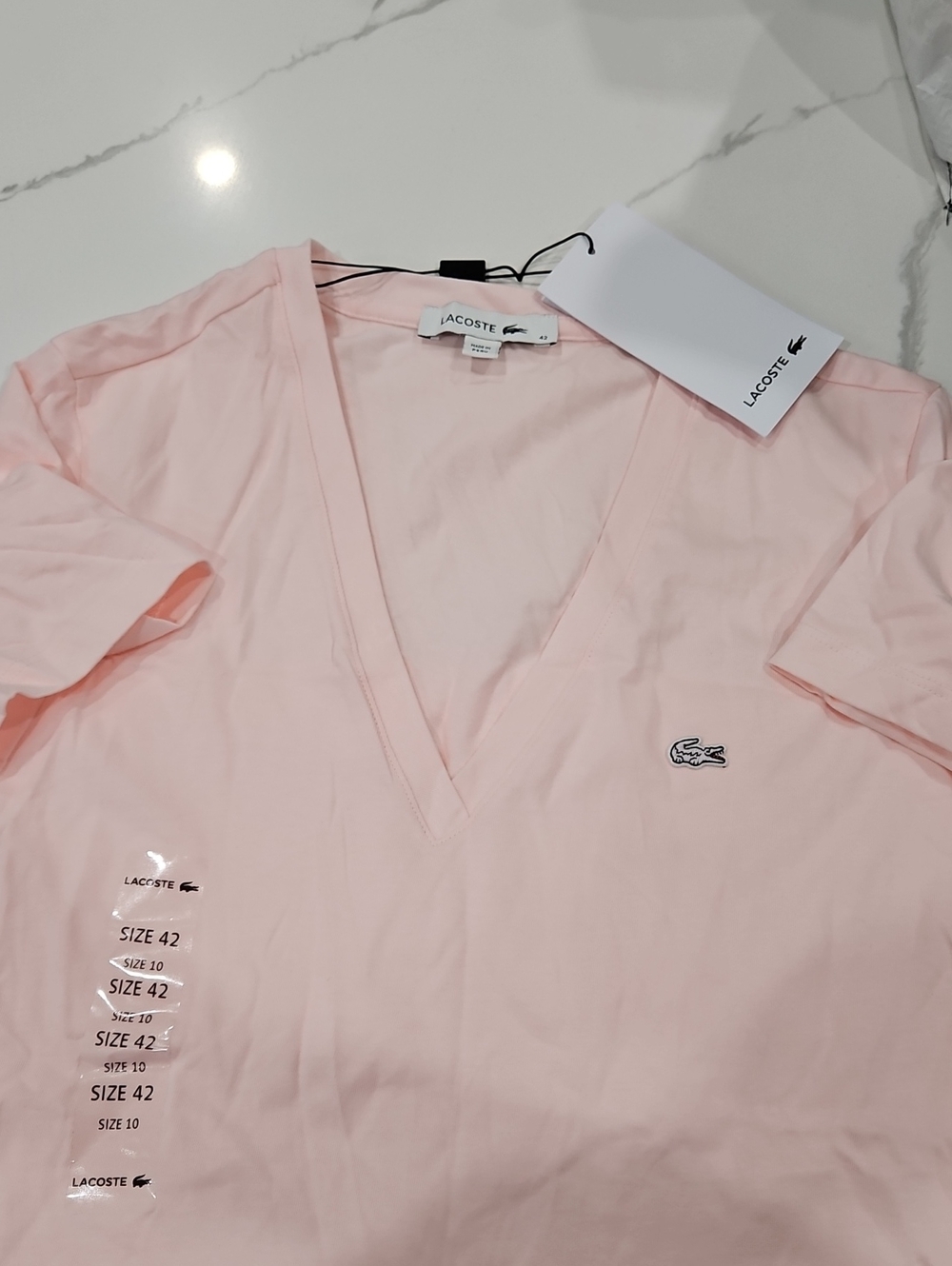 Lacoste Women’s Pale Pink V-Neck Short Sleeve Tee